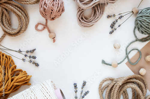 Beautiful layout of materials for macrame: cotton cords, jute twine, wooden beads. Flat lay. photo