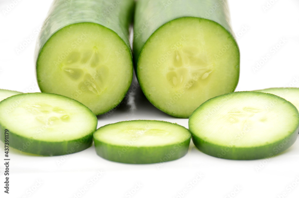closeup the pair of sliced green ripe cucumber isolated on white background.