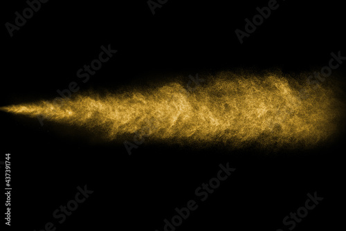 Photos Gold dust, aerosol on black background