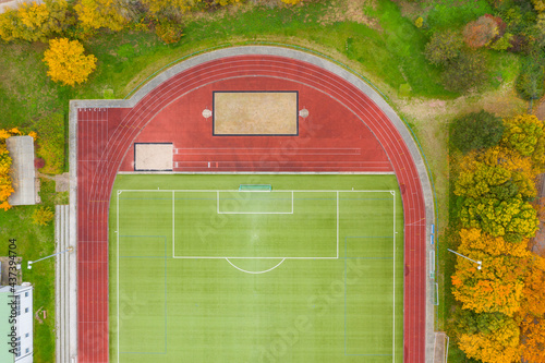 Looking straight down on one half of an empty soccer field with a cinder track  photo