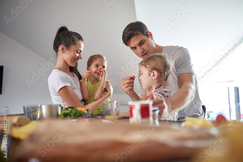 A young happy family enjoying a breakfast at home. Family, breakfast, togetherness