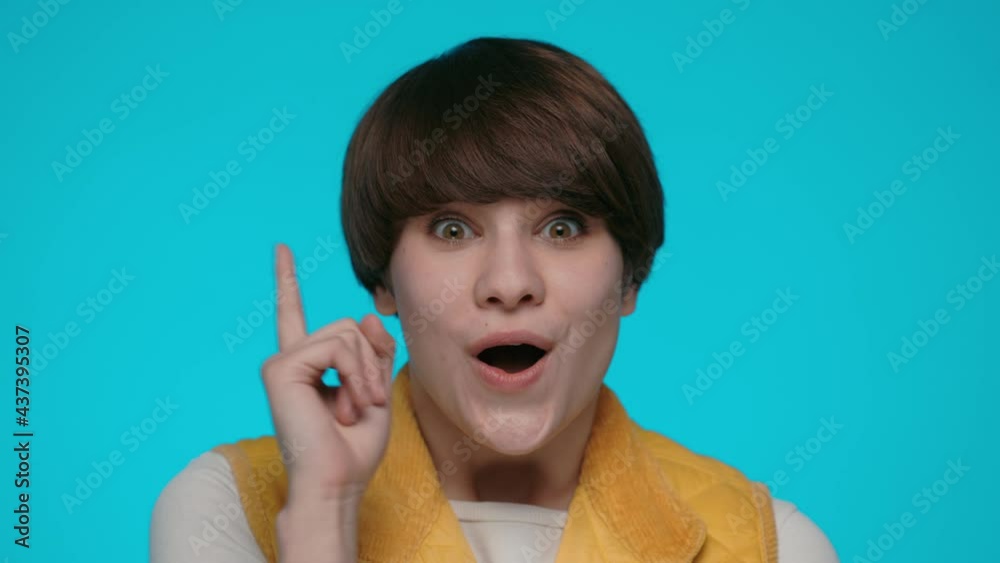 Thoughtful woman with new idea raising forefinger Thoughtful woman with new idea raising forefinger