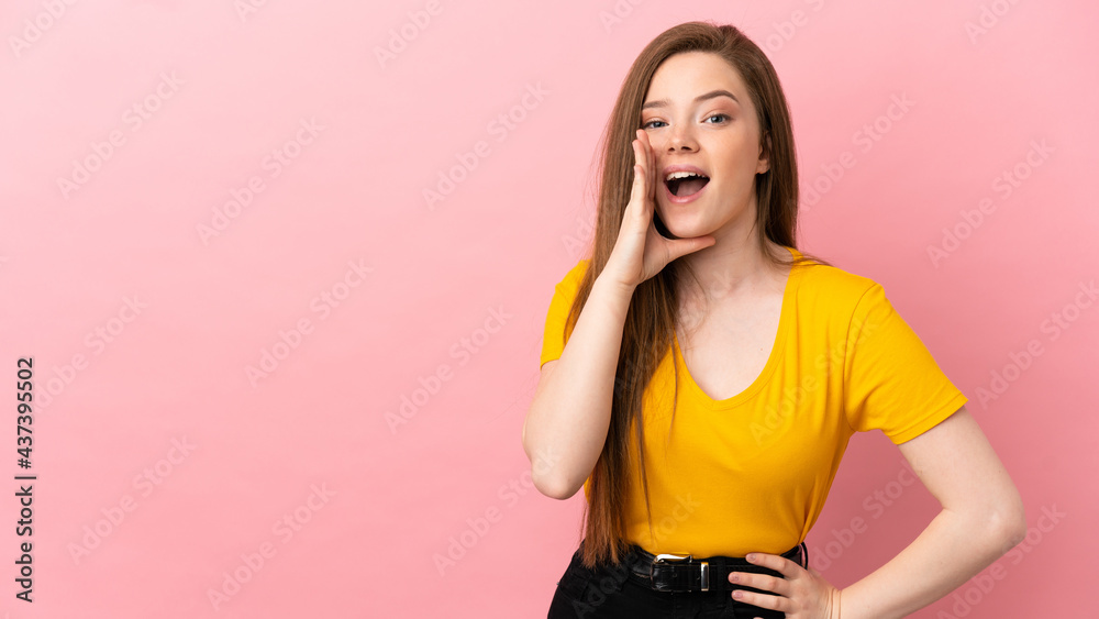Teenager girl over isolated pink background shouting with mouth wide open Teenager girl over isolated pink background shouting with mouth wide open