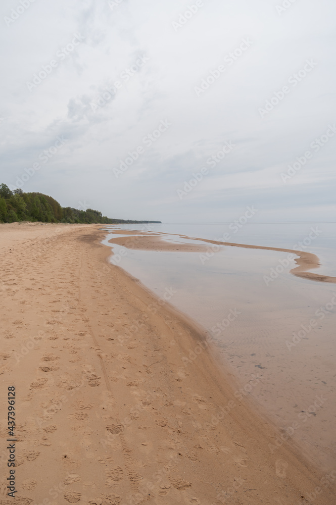 Sandy beach of  Baltic sea in cloudy and calm spring morning
