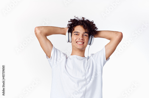 curly guy in headphones listens to music emotions entertainment