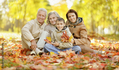 Happy family relaxing in autumn forest