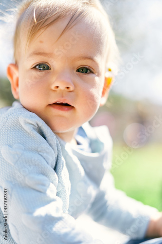 Cute baby in a blue sweater with hearts. Portrait. Close-up