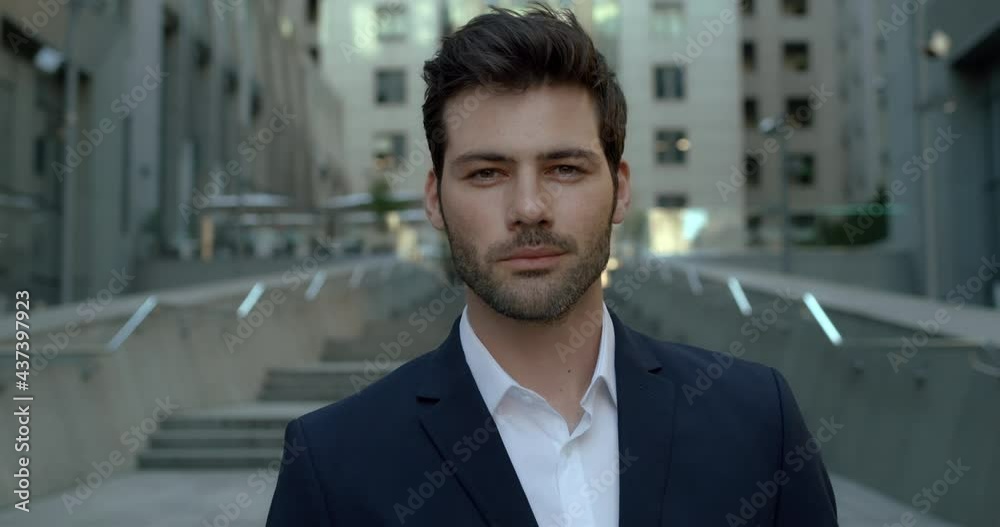 Portrait of Successful smiling Male Entrepreneur standing in Business district. Intelligent Employer with Handsome Face looking at the camera. Wears Luxury Suit. Man Model, Business Appearance. Portrait of Successful smiling Male Entrepreneur standing in Business district. Intelligent Employer with Handsome Face looking at the camera. Wears Luxury Suit. Man Model, Business Appearance.