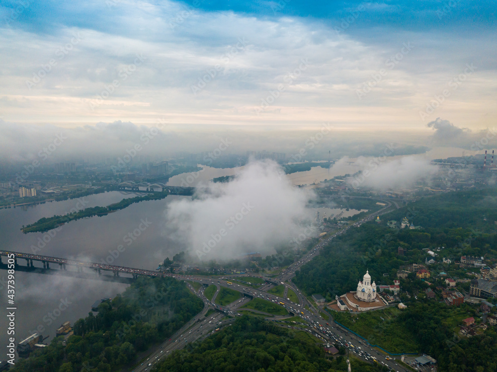 High view of the Dnieper River in Kiev through the clouds. Spring cloudy morning. Aerial high view.