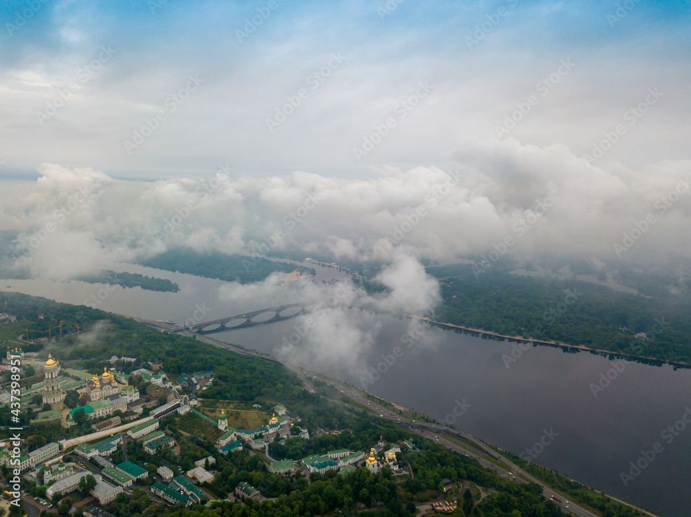 High view of the Dnieper River in Kiev through the clouds. Spring cloudy morning. Aerial high view.