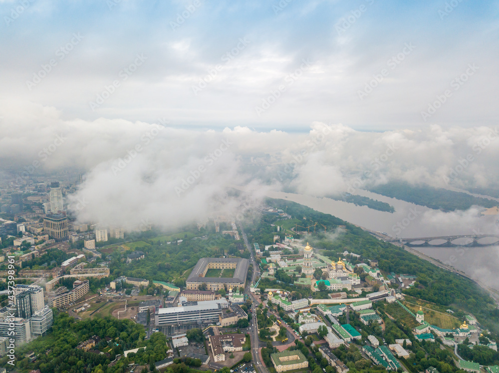 High view of the Dnieper River in Kiev through the clouds. Spring cloudy morning. Aerial high view.