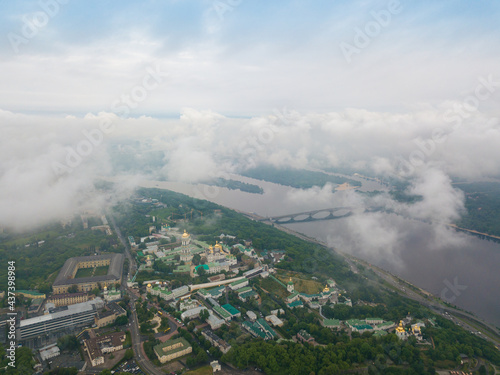 High view of the Dnieper River in Kiev through the clouds. Spring cloudy morning. Aerial high view.