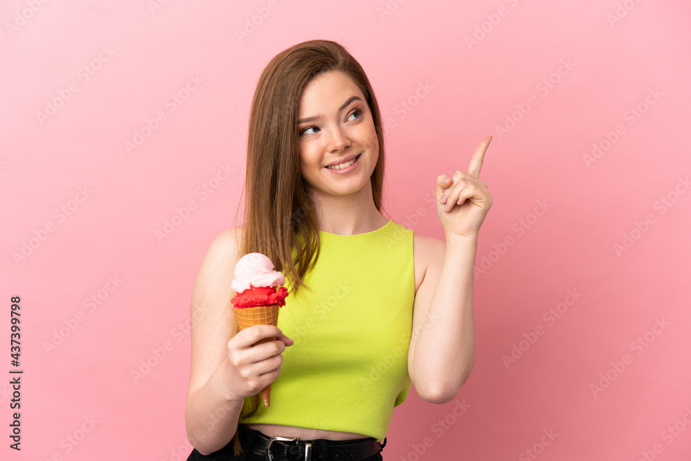 Teenager girl with a cornet ice cream over isolated pink background pointing up a great idea Teenager girl with a cornet ice cream over isolated pink background pointing up a great idea