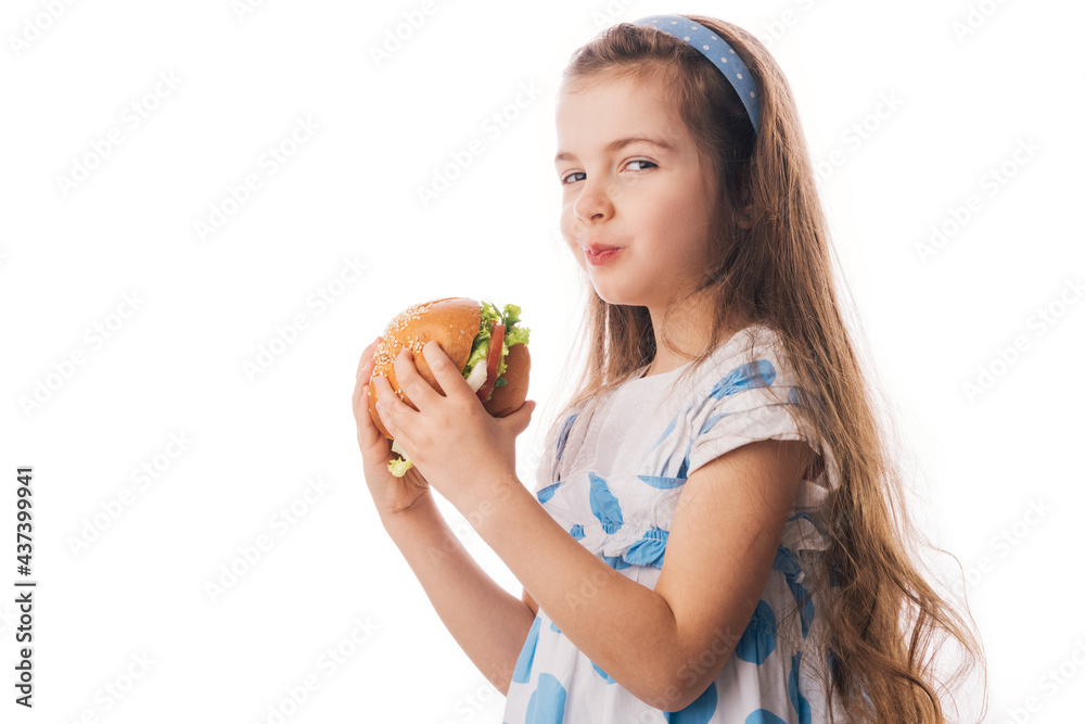 Little girl eating big burger. Kid looking at healthy big sandwich, studio isolated on white background. Little girl eating big burger. Kid looking at healthy big sandwich, studio isolated on white background.