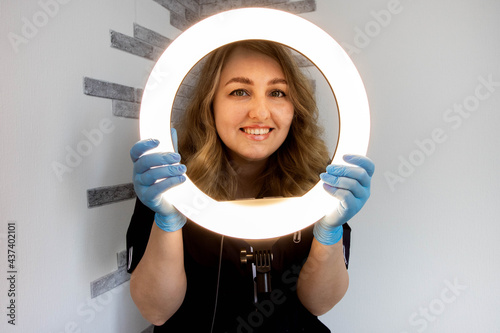 girl beautician with ring lamp photo