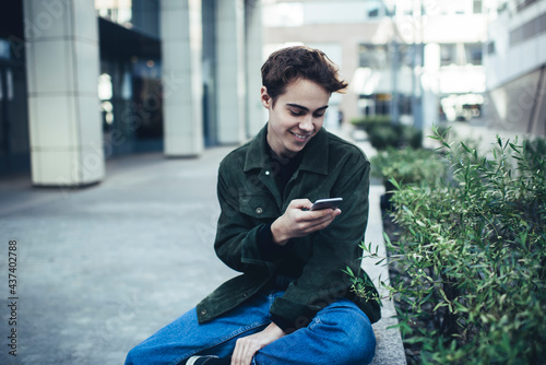 Happy man text messaging on smartphone