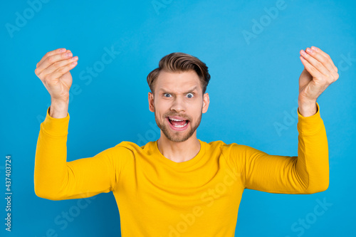 Photo of young guy unhappy upset angry mad crazy accuse argument conflict isolated over blue color background