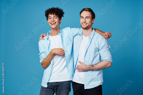 friends hugging on a blue background fun matching shirts white t-shirt pants
