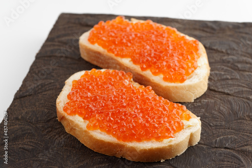 Two loaves of bread with red salmon roe
