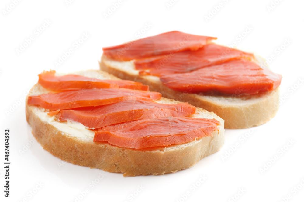 Sandwiches with smoked trout on white surface with shadow
