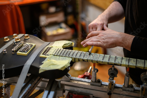 Black electrical guitar in repair service shop