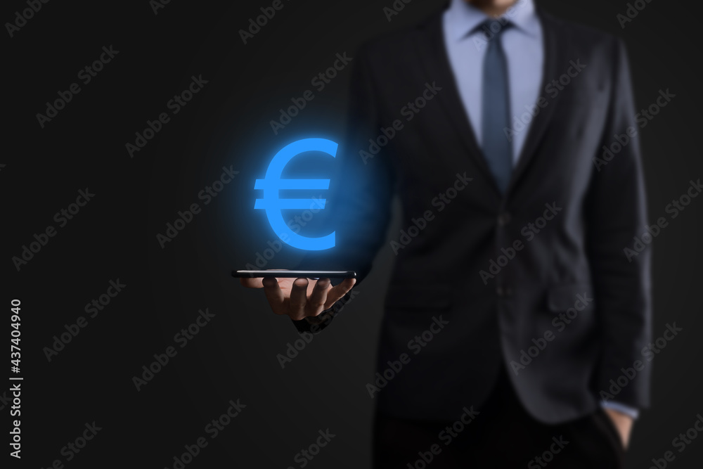 Businessman holds money coin icons EUR or Euro on dark tone background..Growing money concept for business investment and finance Businessman holds money coin icons EUR or Euro on dark tone background..Growing money concept for business investment and finance