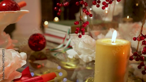The atmosphere of waiting for Christmas. Fireplace, candles, Christmas balls.