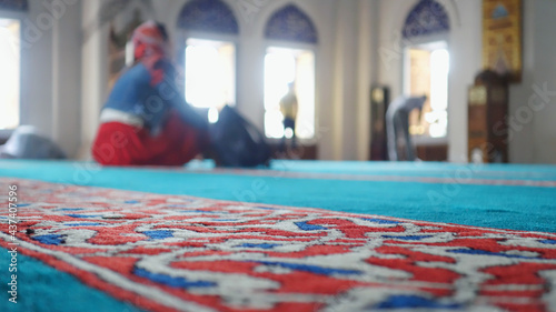 Photography A woman prays inside a mosque.