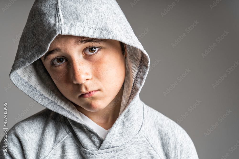 portrait of young and cute teenager with hoodies on studio grey portrait of young and cute teenager with hoodies on studio grey