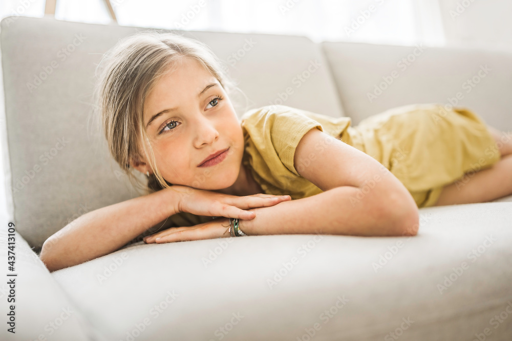 Portrait of little girl laying on couch Portrait of little girl laying on couch