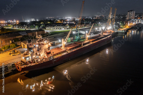 A Transport Ship Docked at Night Awaiting Cargo Loading