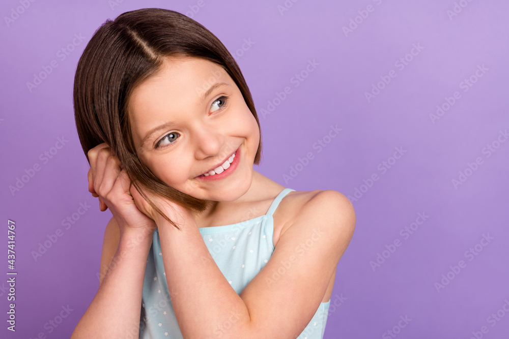 Photo of happy charming nice little girl look empty space good mood isolated on purple color background Photo of happy charming nice little girl look empty space good mood isolated on purple color background