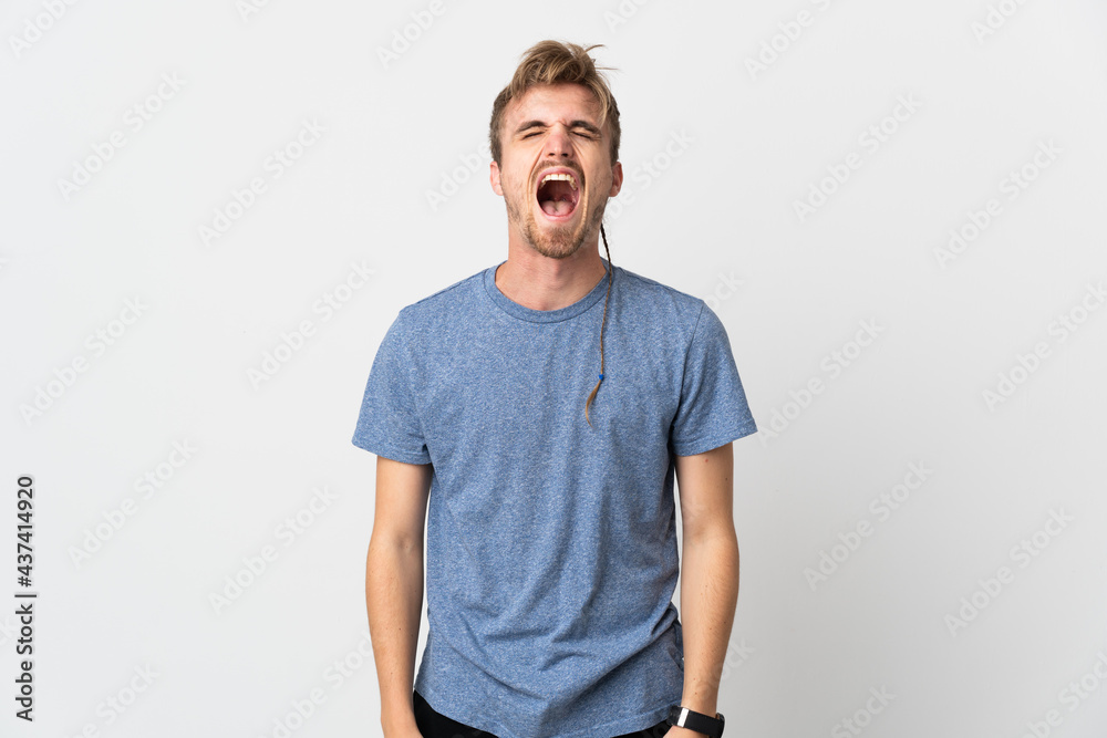 Fototapeta premium Young handsome man isolated on white background shouting to the front with mouth wide open