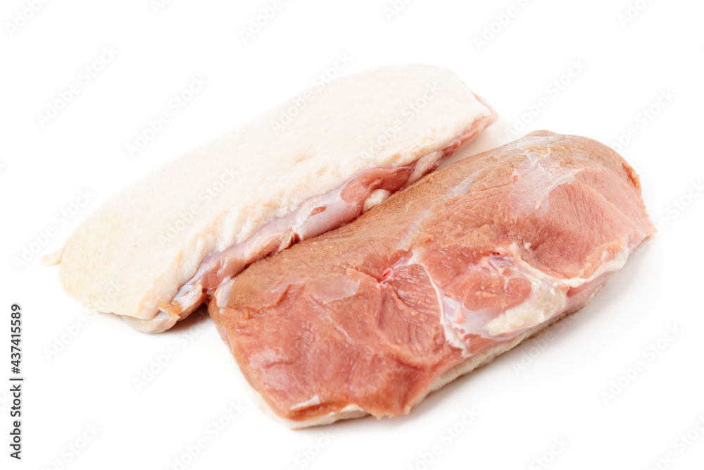 Two raw duck breast fillets on white surface