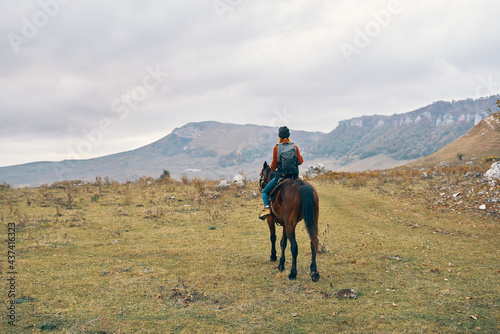 woman hiker with backpack riding horse landscape mountains fresh air © SHOTPRIME STUDIO