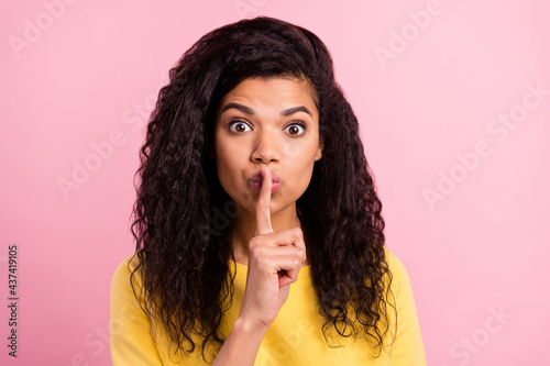 Photo of young afro girl finger cover lips shh keep secret conspiracy shut up isolated over pink color background