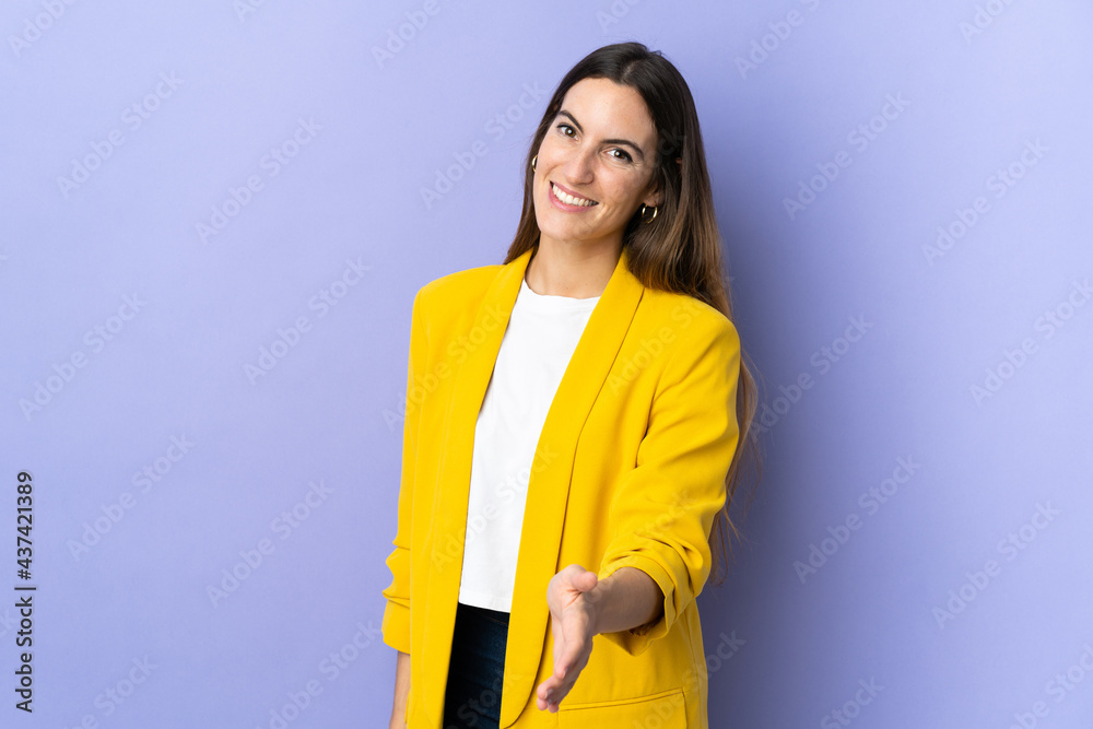 Young caucasian woman over isolated background shaking hands for closing a good deal Young caucasian woman over isolated background shaking hands for closing a good deal