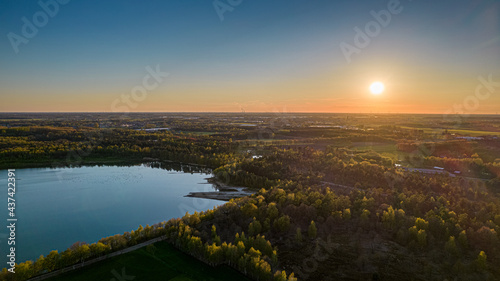 Fototapeta Naklejka Na Ścianę i Meble -  Beautiful aerial view on the forest lake at sunset in Belgium in spring time, shot with a drone. High quality photo