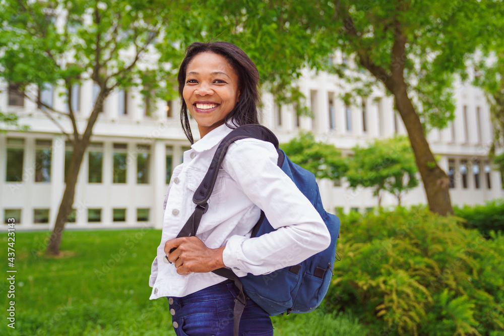 A black adult woman university student on campus with backpack A black adult woman university student on campus with backpack