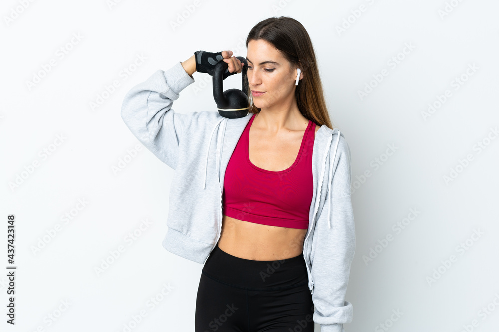 Young sport woman over isolated background making weightlifting with kettlebell Young sport woman over isolated background making weightlifting with kettlebell