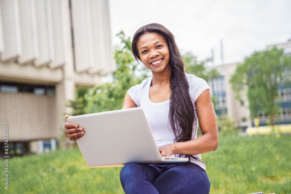 A black adult woman university student on campus with backpack A black adult woman university student on campus with backpack