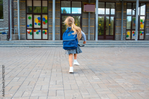 little girl with backpack run back to school.