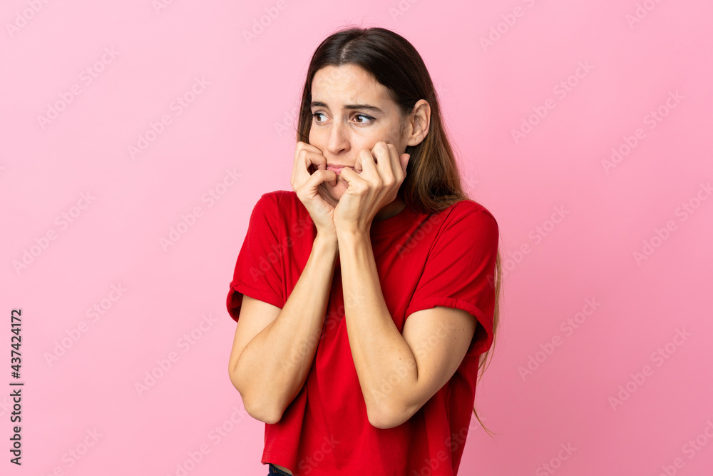 Young caucasian woman isolated on pink background nervous and scared putting hands to mouth Young caucasian woman isolated on pink background nervous and scared putting hands to mouth