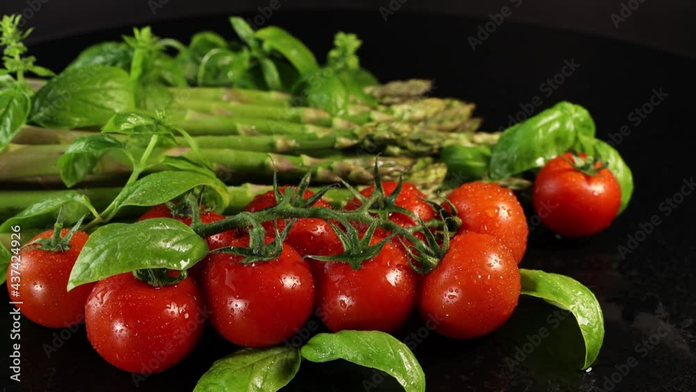 Cherry tomatoes, green basil leaves and asparagus Cherry tomatoes, green basil leaves and asparagus