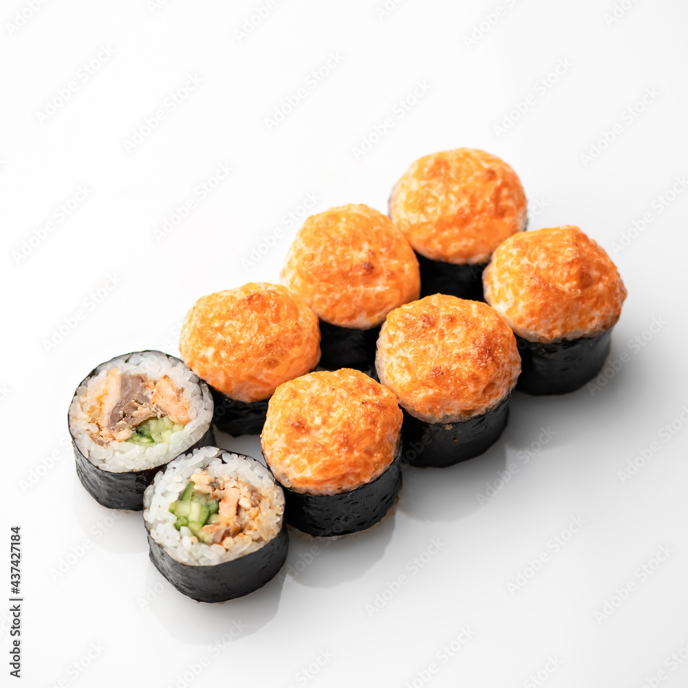 Hot baked Sushi roll isolated on white background. Traditional Japanese food. Healthy Oriental meal. Wellness concept. Top Side view. Soft focus. Hot baked Sushi roll isolated on white background. Traditional Japanese food. Healthy Oriental meal. Wellness concept. Top Side view. Soft focus.