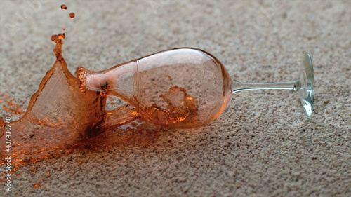 A glass of wine spilled onto the carpet