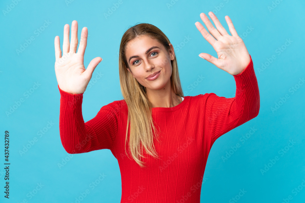 Young blonde woman isolated on blue background counting ten with fingers Young blonde woman isolated on blue background counting ten with fingers
