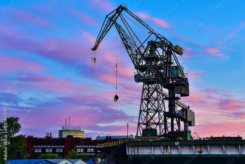 Beautiful sunset and cranes in a shipyard in Gdansk, Poland