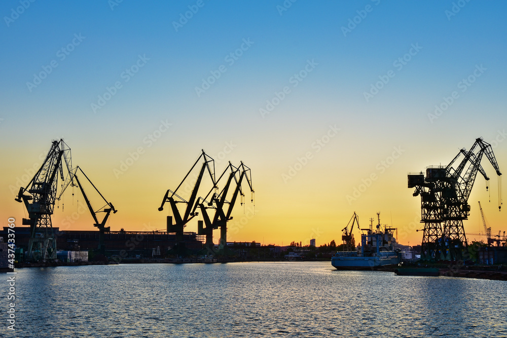 Beautiful sunset and cranes in a shipyard in Gdansk, Poland