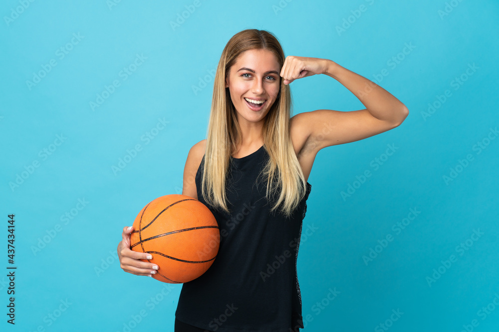 Young woman playing basketball  isolated on white background doing strong gesture